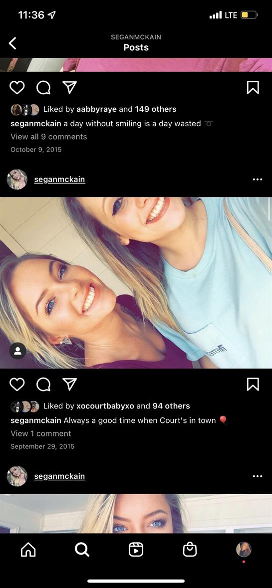 Two friends share smiles and laughter together while enjoying their time at home.