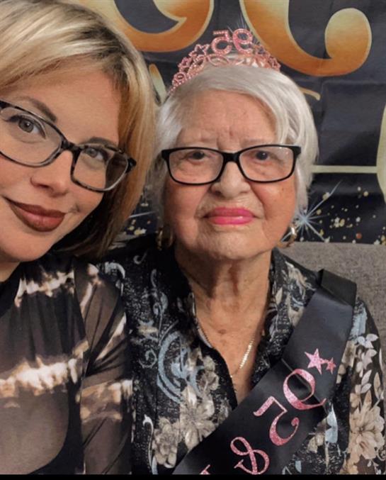 Two family members share a joyful moment celebrating a special birthday during a festive event.