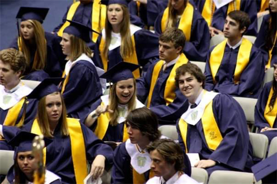 Smiling graduates celebrate their achievements during a graduation ceremony.