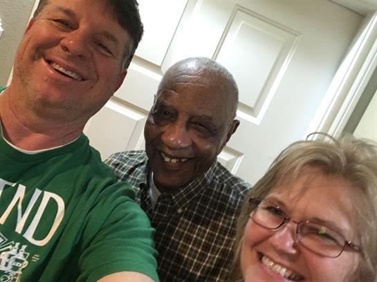 Three friends share a joyful moment, smiling together and showing true camaraderie.