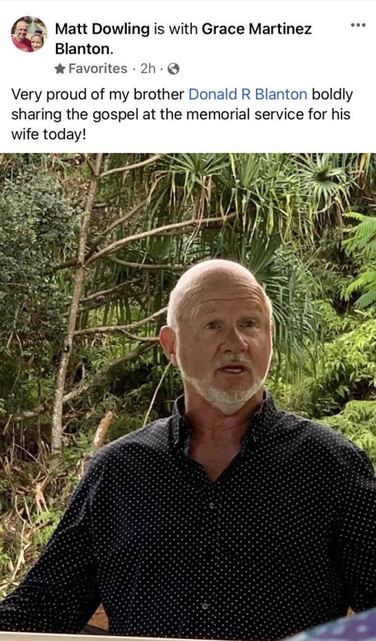 A man enjoys a joyful moment outdoors, celebrating a special occasion with nature around him.