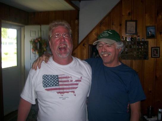 Two friends happily embrace in a warm wooden interior, enjoying each other's company.