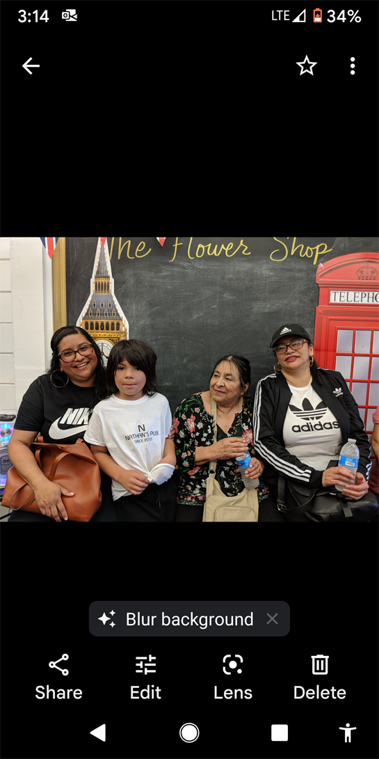 Four people smile at a flower shop, sharing a joyful moment filled with laughter.