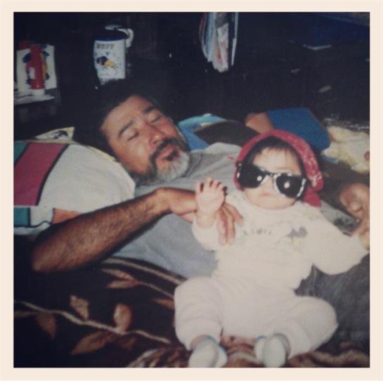 A father and baby share laughs and affection on a warm afternoon.