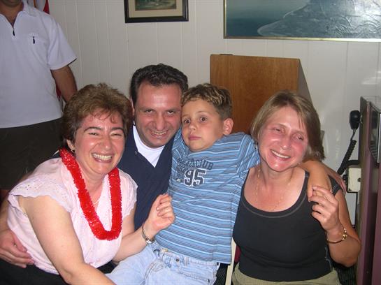 Four people share laughter and joy as they pose together in a warm atmosphere.