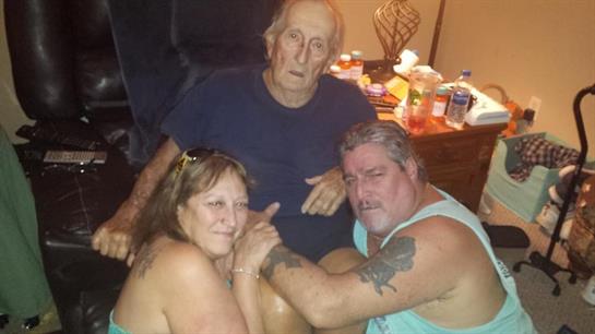 Three family members enjoy each other's company in a cozy atmosphere, sharing laughter and stories.