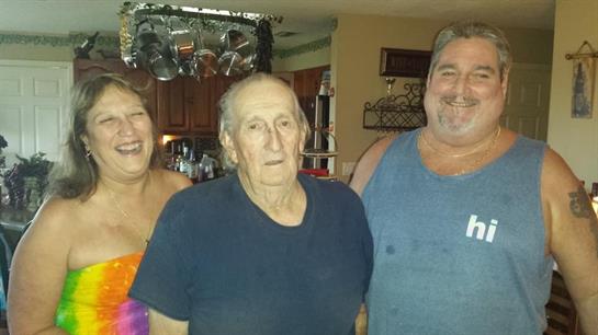 Family members enjoying a happy moment together in a cozy kitchen, sharing smiles and laughter.
