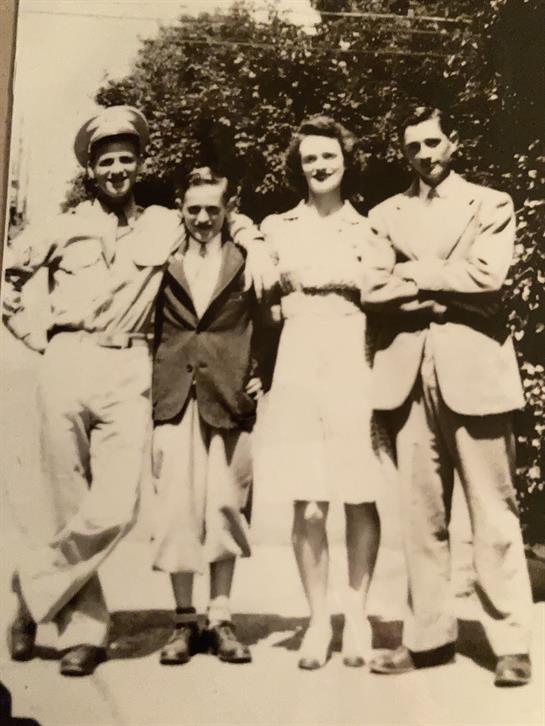 Friends gather outdoors, embodying mid-20th century fashion and friendship in a lively atmosphere.