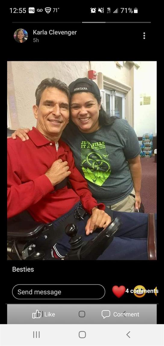 Two individuals share smiles while engaging in a group activity at a rehabilitation center.