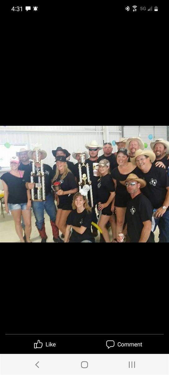 Celebration of achievements with friends, showcasing trophies in a lively indoor setting.