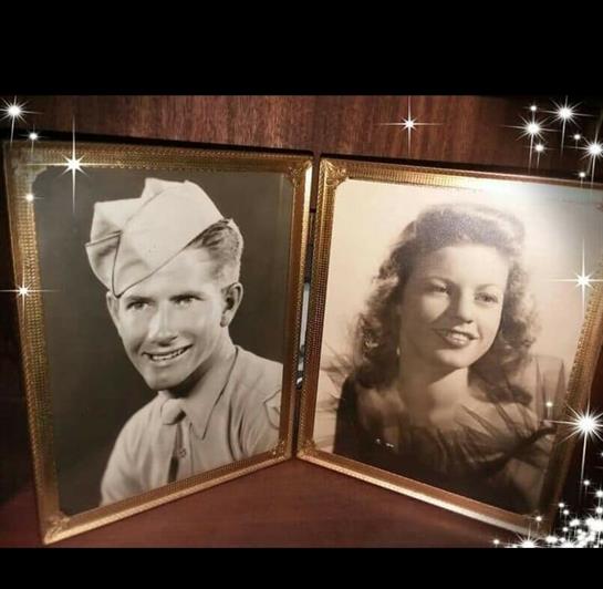 Two vintage portraits of a man in military uniform and a woman smiling, framed together on display.