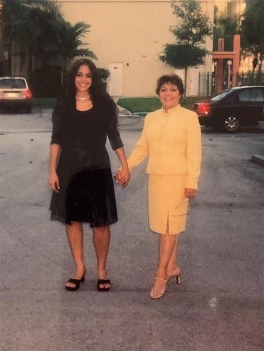 Women in stylish outfits stroll together, enjoying each other's company on a city street.