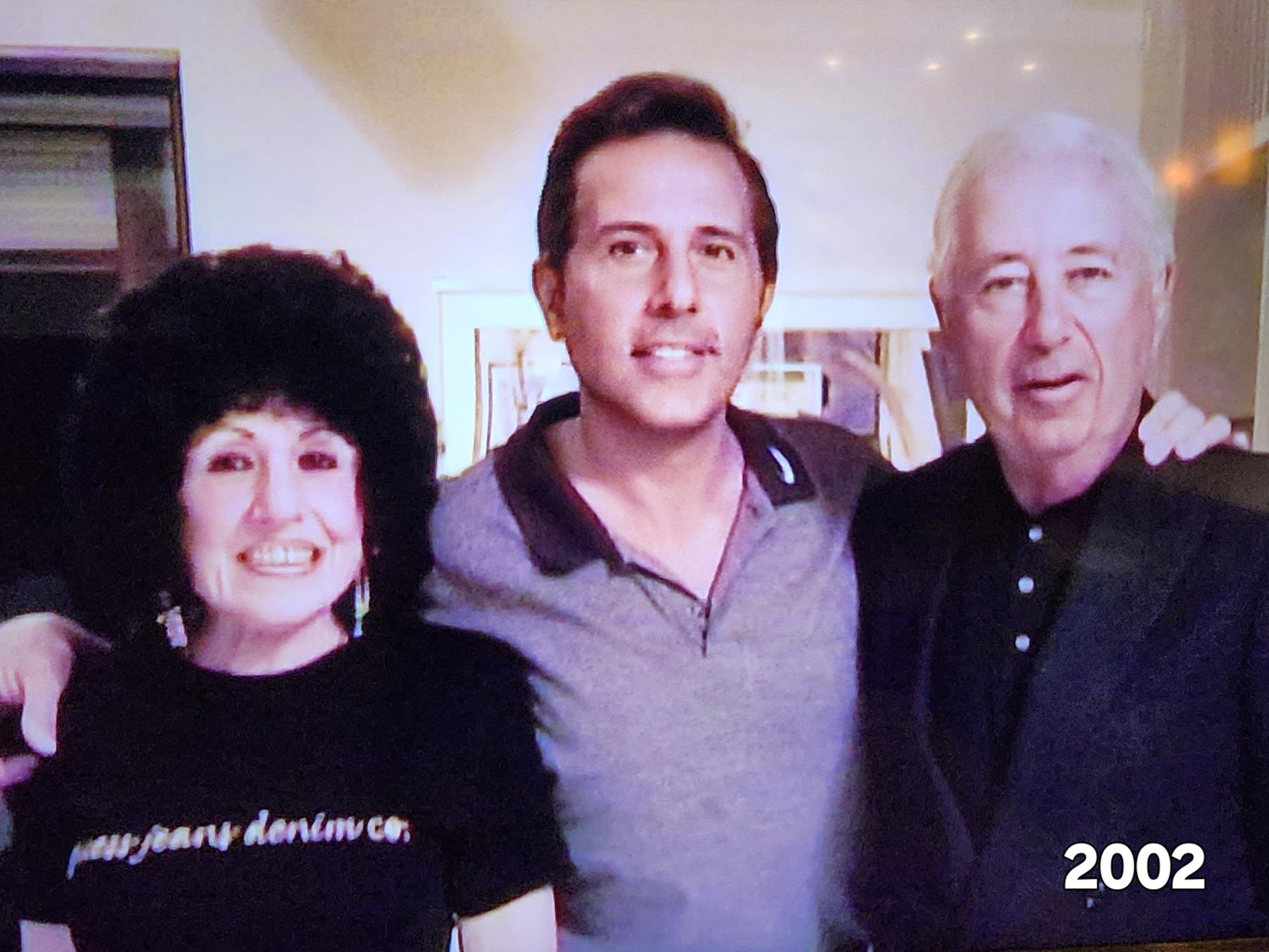 Three friends smiling together in a cozy living room, enjoying a cheerful moment, circa 2002.