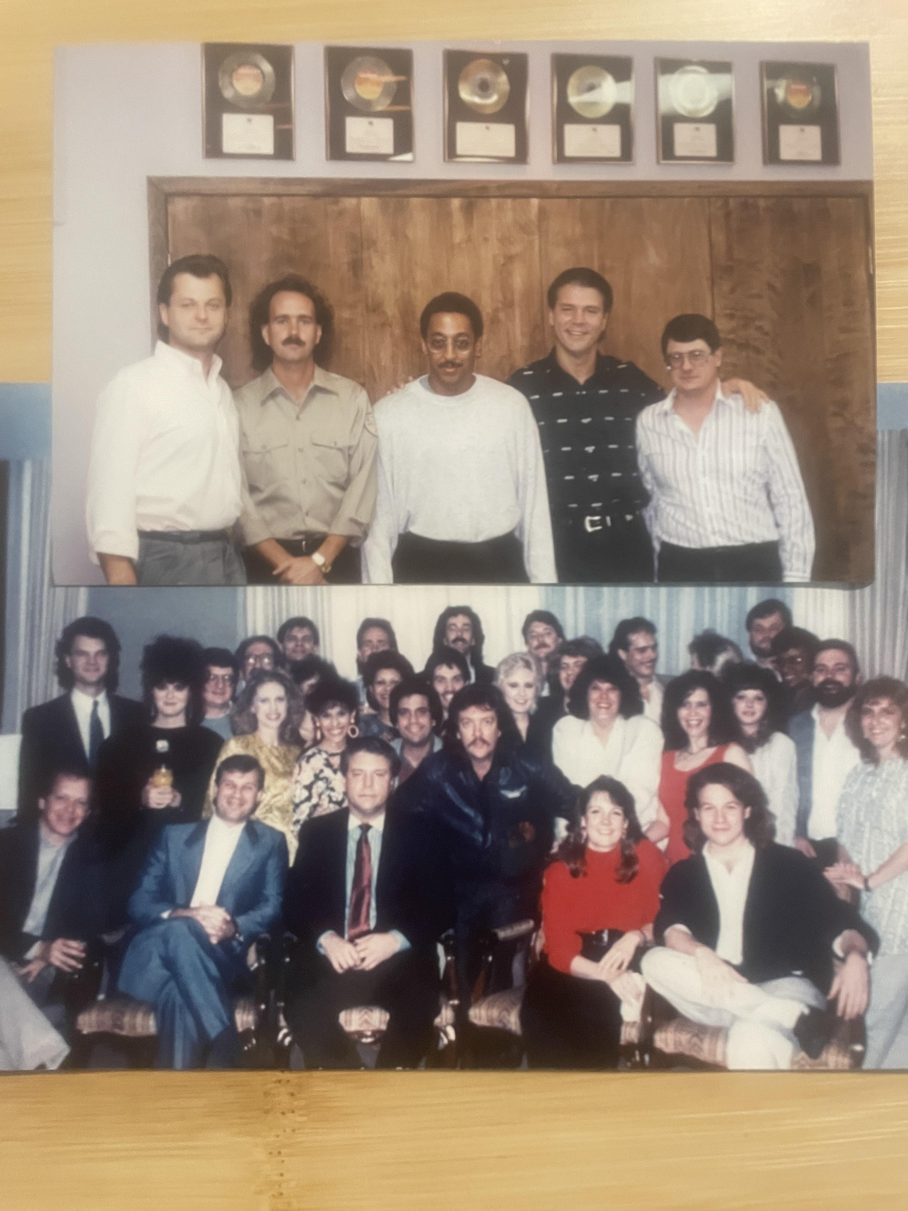 A large group of people poses for a photo, showcasing camaraderie and joy in a warm atmosphere.