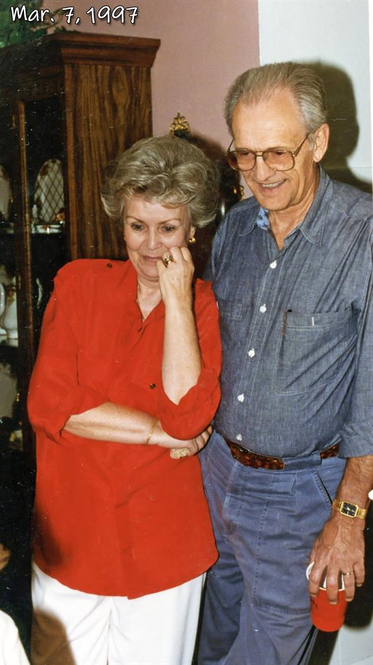 Two people share a light moment in a cozy room filled with collectibles.