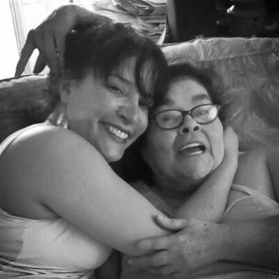 Women enjoy each other's company while cuddling on a couch in a casual living area.