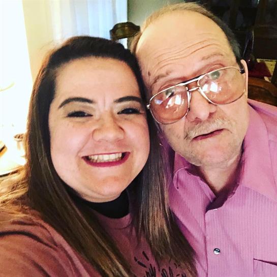 Two relatives smile for a selfie, capturing a joyful moment filled with warmth and connection.