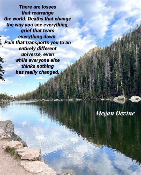 A peaceful lakeside captures profound reflections on grief and healing amidst mountains.