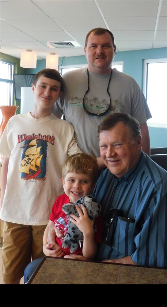 Family gathering shows joyful moments of a grandfather with his smiling grandsons.