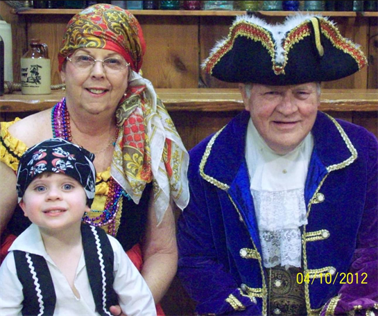 Family members enjoy a playful pirate-themed gathering in vibrant costumes at a community event.