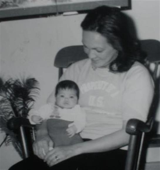 A mother enjoys a tender moment with her newborn baby in a warm and inviting room.