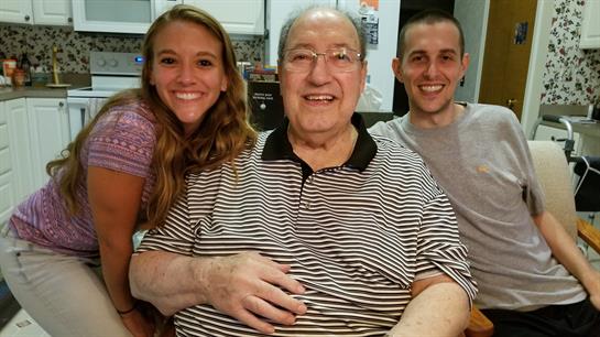 Family members celebrate their time together, sharing smiles and laughter at home in the evening.