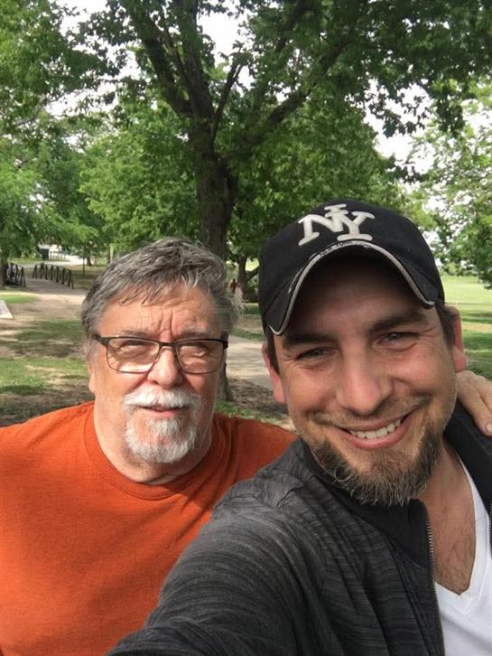 Two friends enjoy a sunny day in spring, posing for a cheerful selfie surrounded by trees.