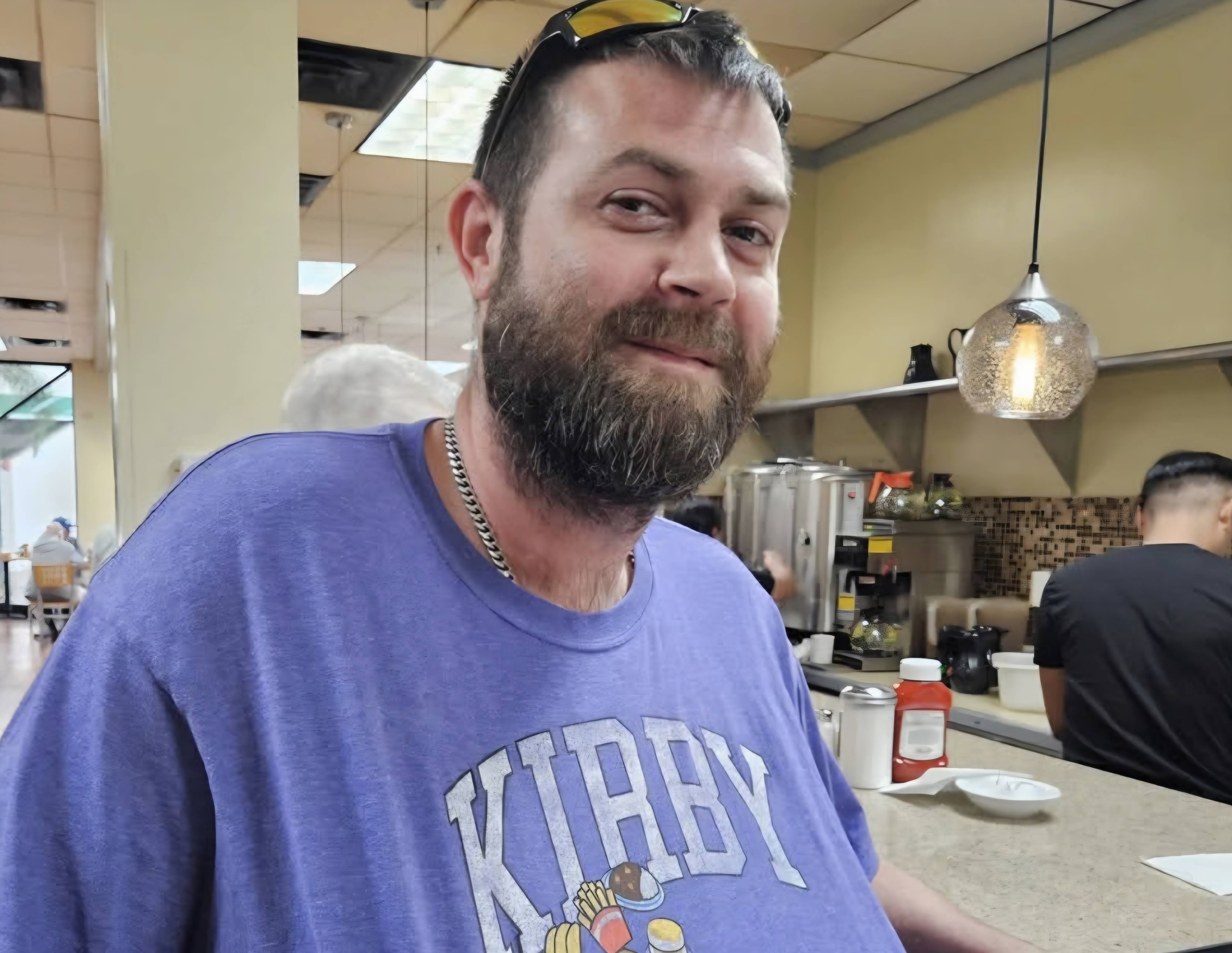 A man with a beard smiling