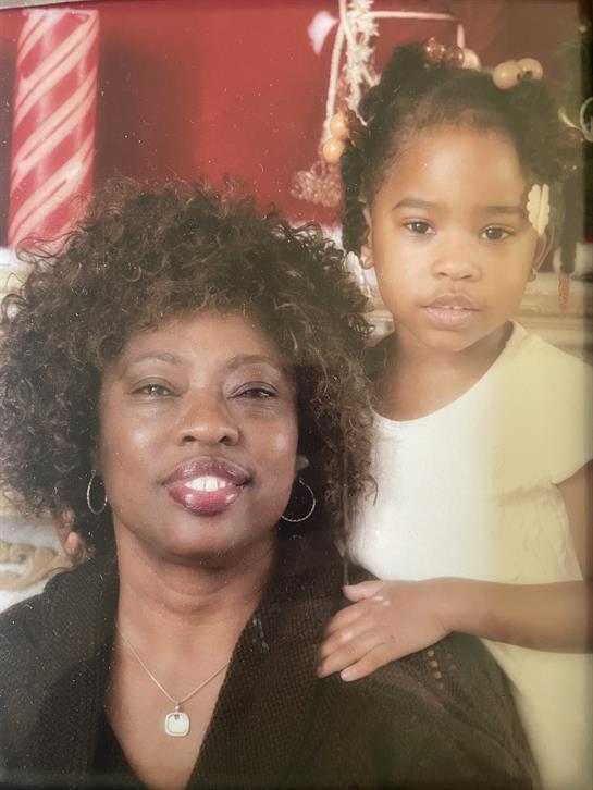 A joyful moment shared between a woman and a girl, capturing their bond in a festive setting.
