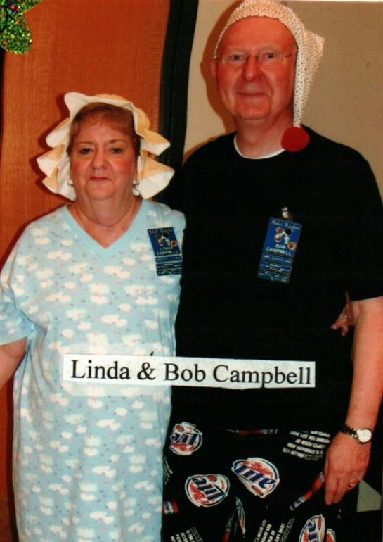 A couple poses together in matching attire at a community gathering, showcasing their spirit.