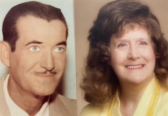 A couple in elegant attire smiles warmly in a timeless, nostalgic moment.