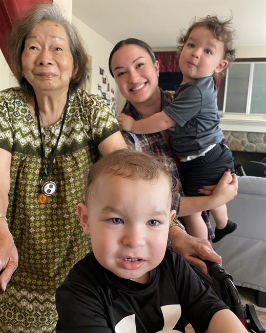 Three generations of a family share joyful moments together in a cozy living room setting.