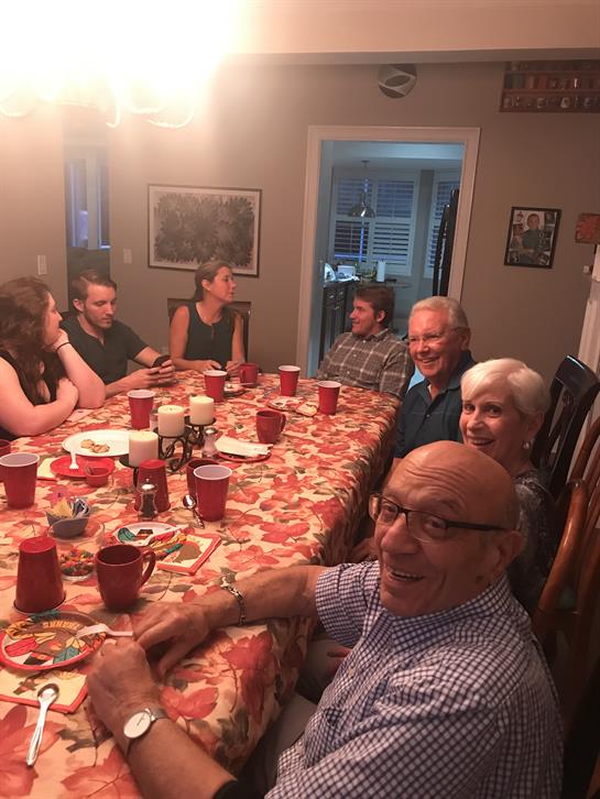 Friends and family share laughter and stories during a lively dinner in a warm atmosphere.