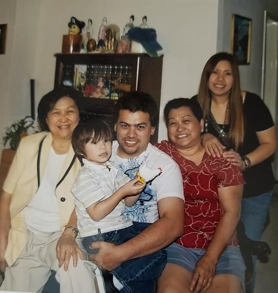 A cheerful family poses together in a cozy room, enjoying their time with laughter and love.