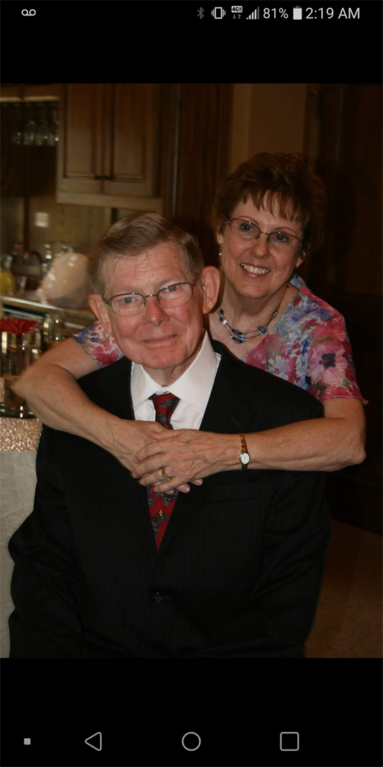 Two individuals share a heartfelt moment at a celebration, radiating warmth and connection.