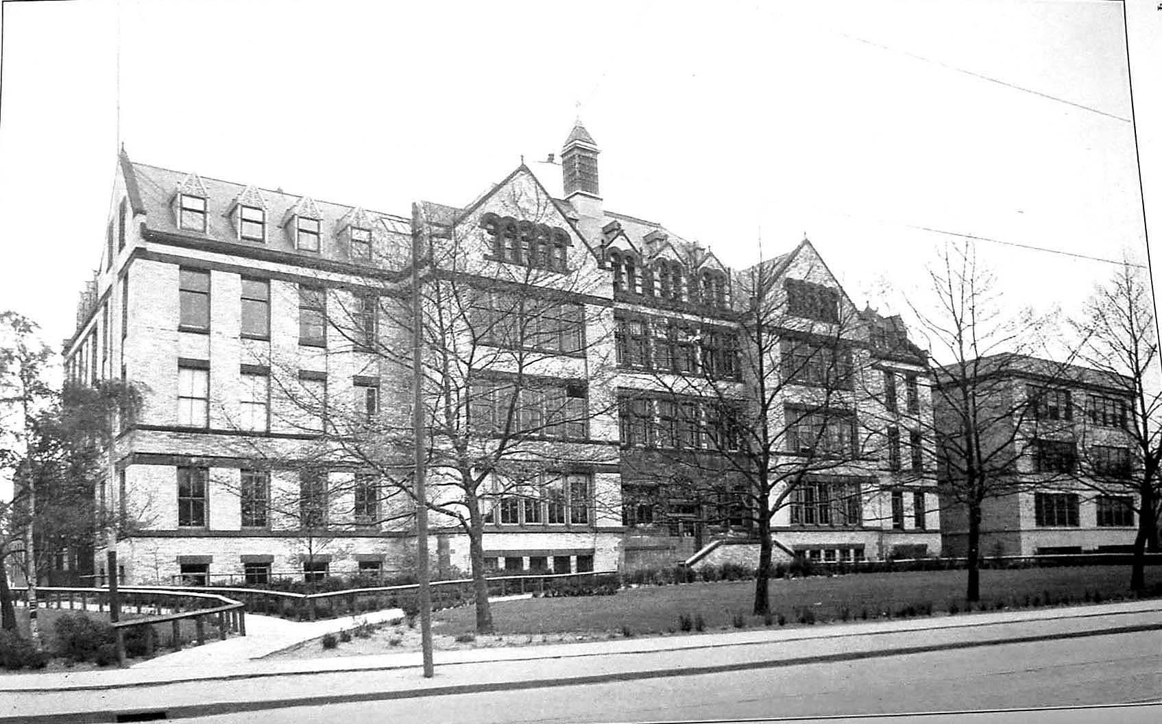 A large building with trees in front
