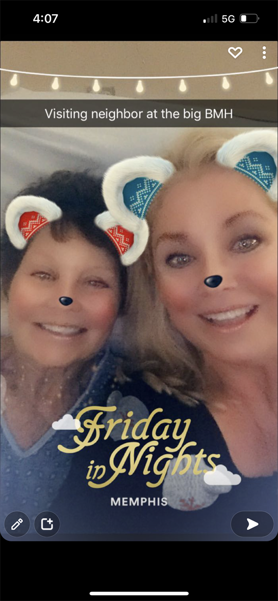 Two friends smiling happily with playful animal filters, sharing a joyful moment together indoors.