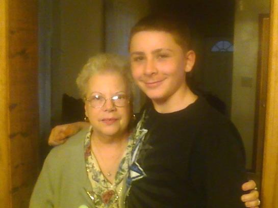 Young boy shares a loving embrace with his grandmother in a cozy home environment.
