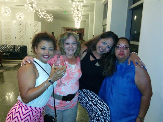 Four friends celebrating together in an elegant setting, showcasing joy and friendship.