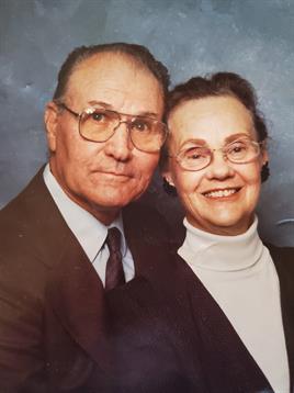 Two seniors pose closely with joyful expressions, capturing a moment of love and companionship.