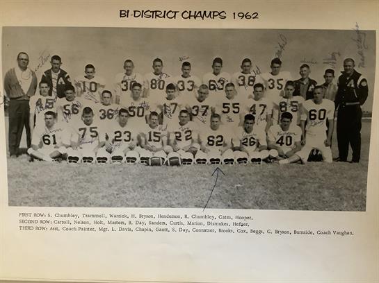 Celebrating a championship, this football team showcases their unity and accomplishment in 1962.