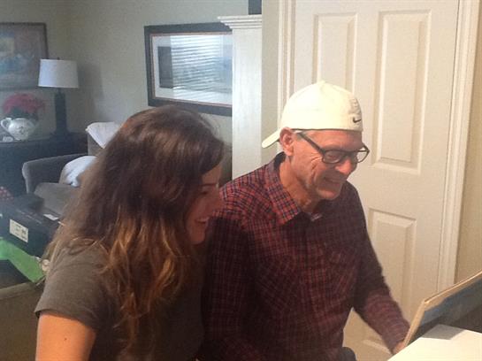 Two people share laughter and music in a warm living room, creating happy memories together.