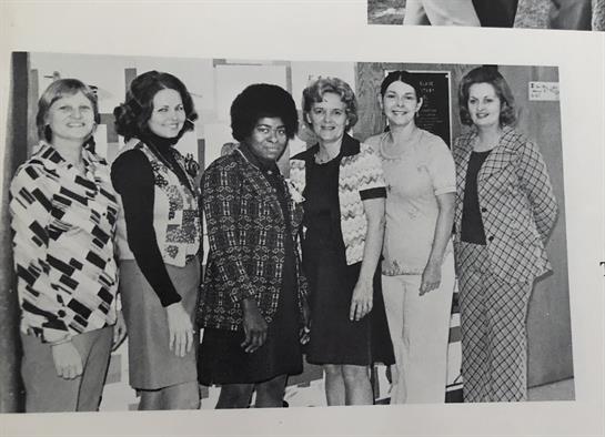 Diverse women smile together, showcasing 1970s fashion and friendship.