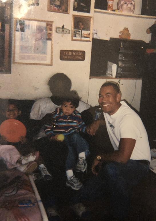 Family members enjoy each other's company while sitting together in a warm, inviting living room.