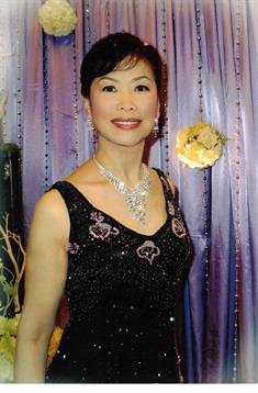 Woman in a glamorous black dress exudes elegance at a festive gathering.
