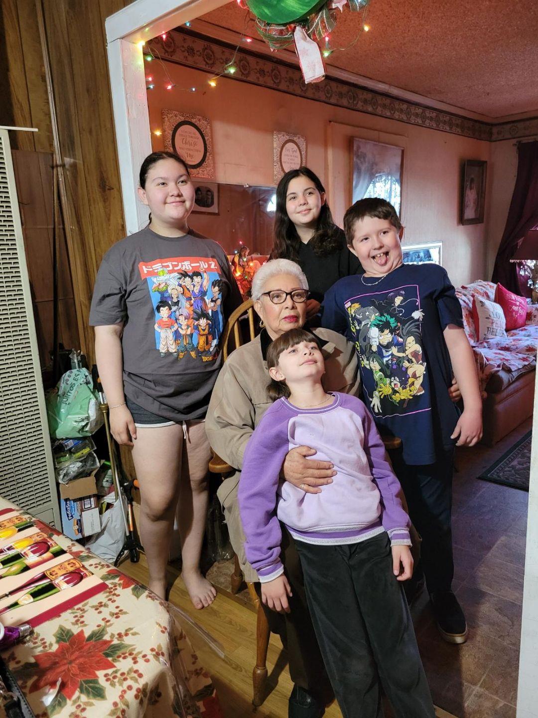 A joyful family celebrates together, showing love and smiles in a warmly decorated living room.