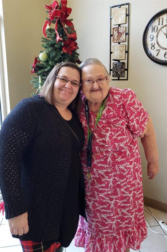 Women enjoy quality time together, sharing smiles in a cozy, decorated living space.