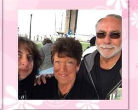Three friends pose for a cheerful moment during a relaxed outdoor gathering near the water.