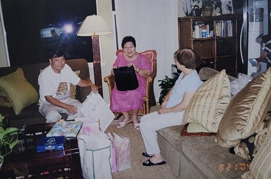 Family members enjoy each other's company while celebrating in a comfortable living space.