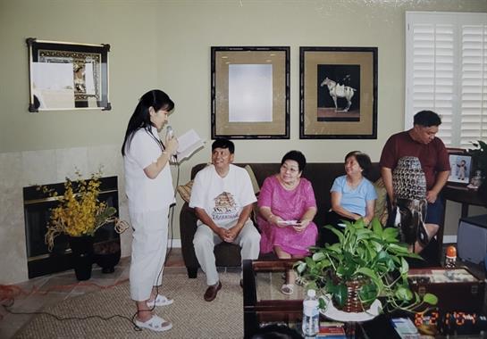 Family members share stories in a cozy living room, creating warm memories together.